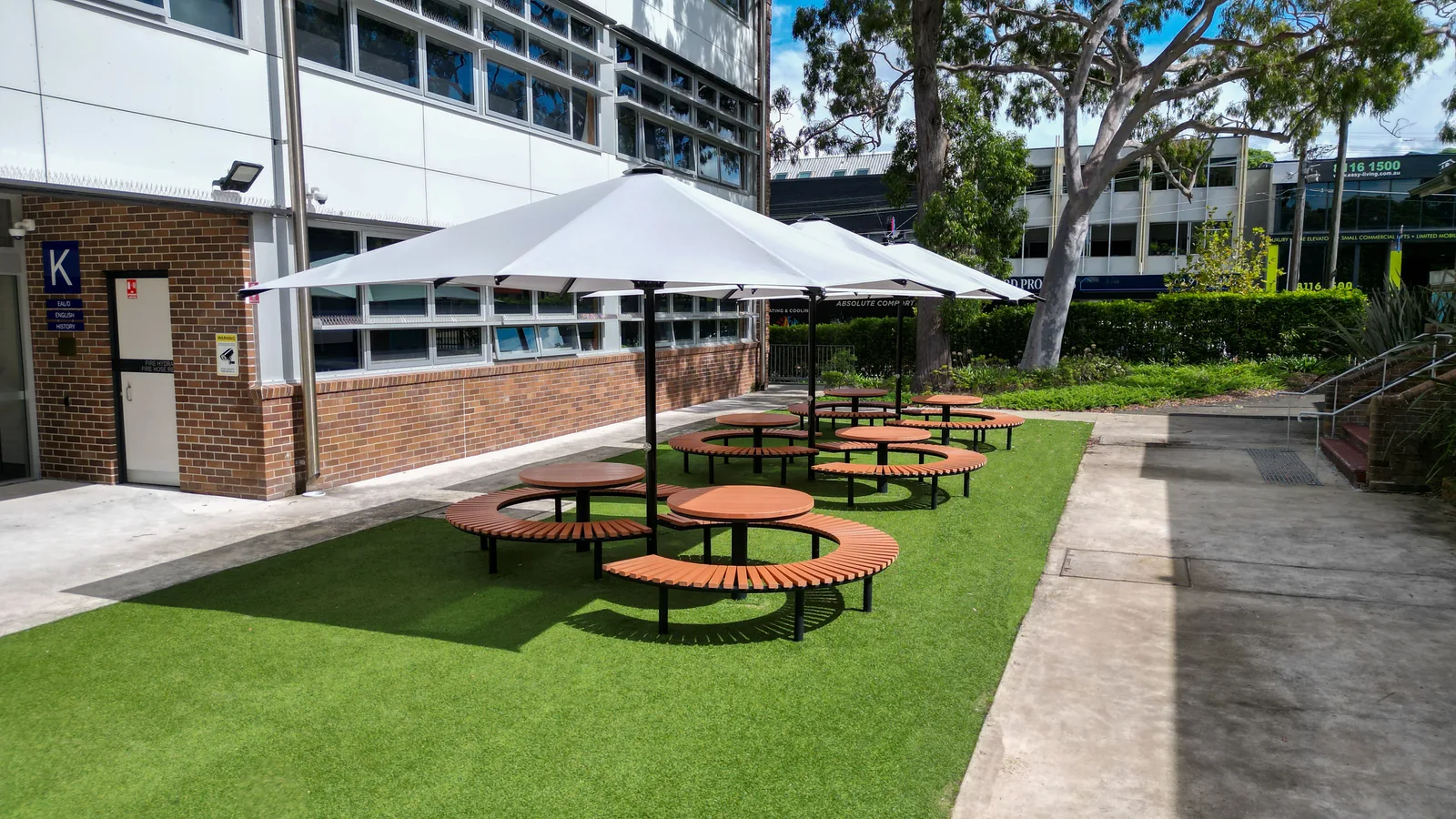 Conrod double settings under a heavy duty umbrella on synthetic grass