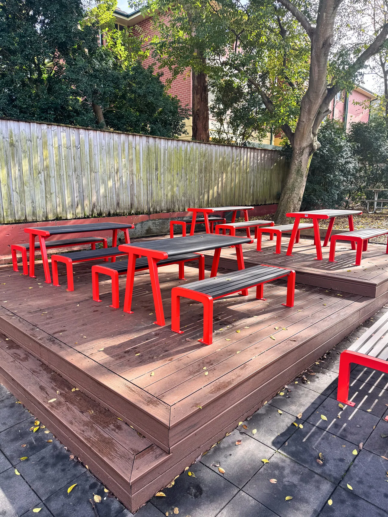 Red Seville settings on a timber deck
