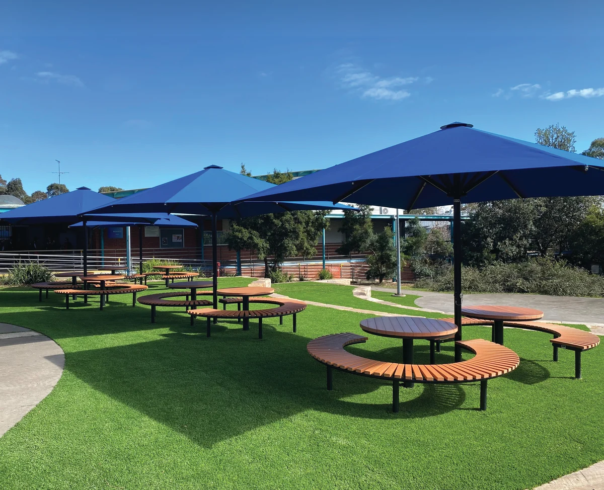 Navy umbrellas over outdoor settings at Quakers Hill High School