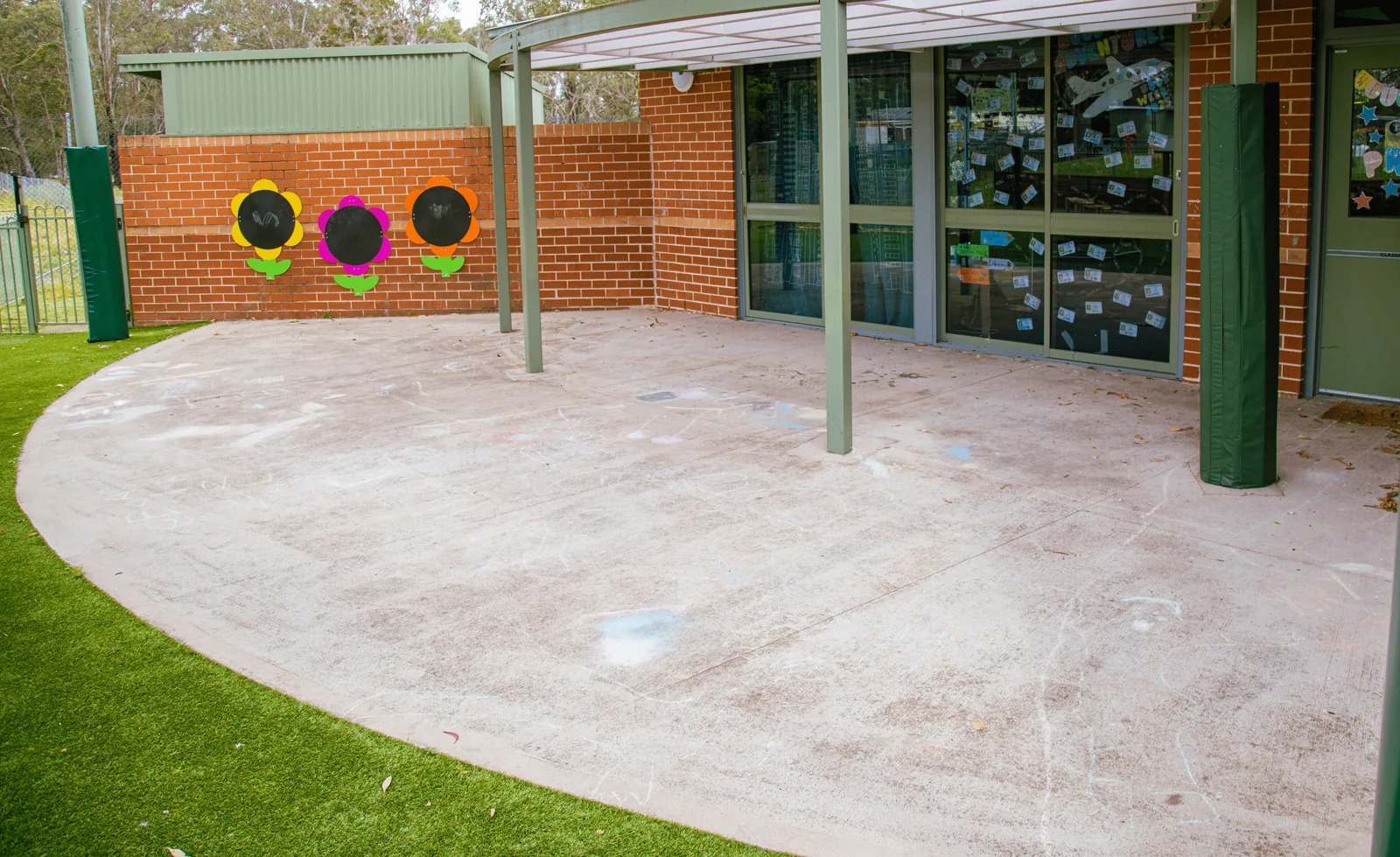 Plain concrete play area outside a classroom before playground markings