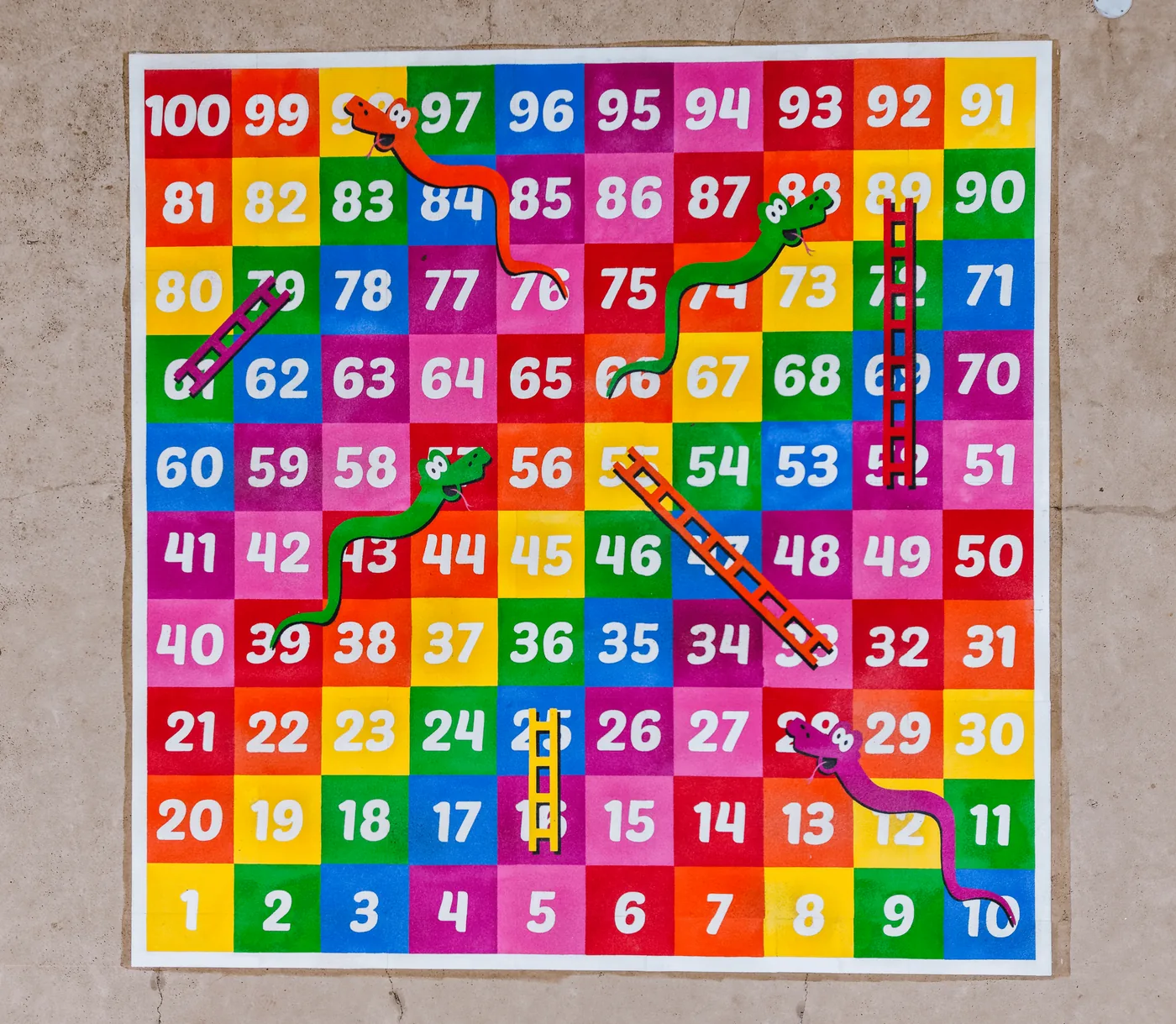Colourful thermoplastic snakes and ladders playground marking at a school