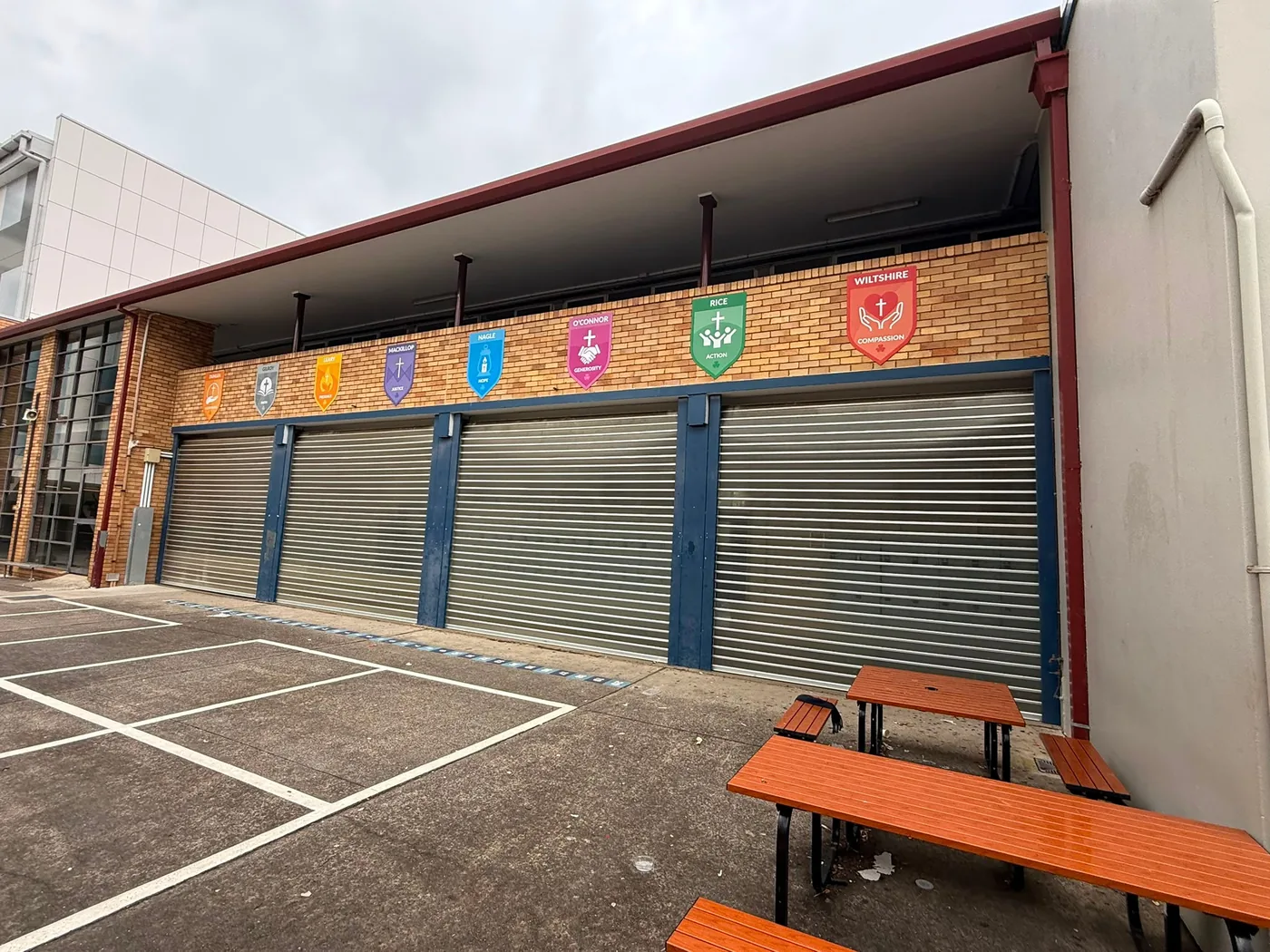 House crest murals on school roller doors