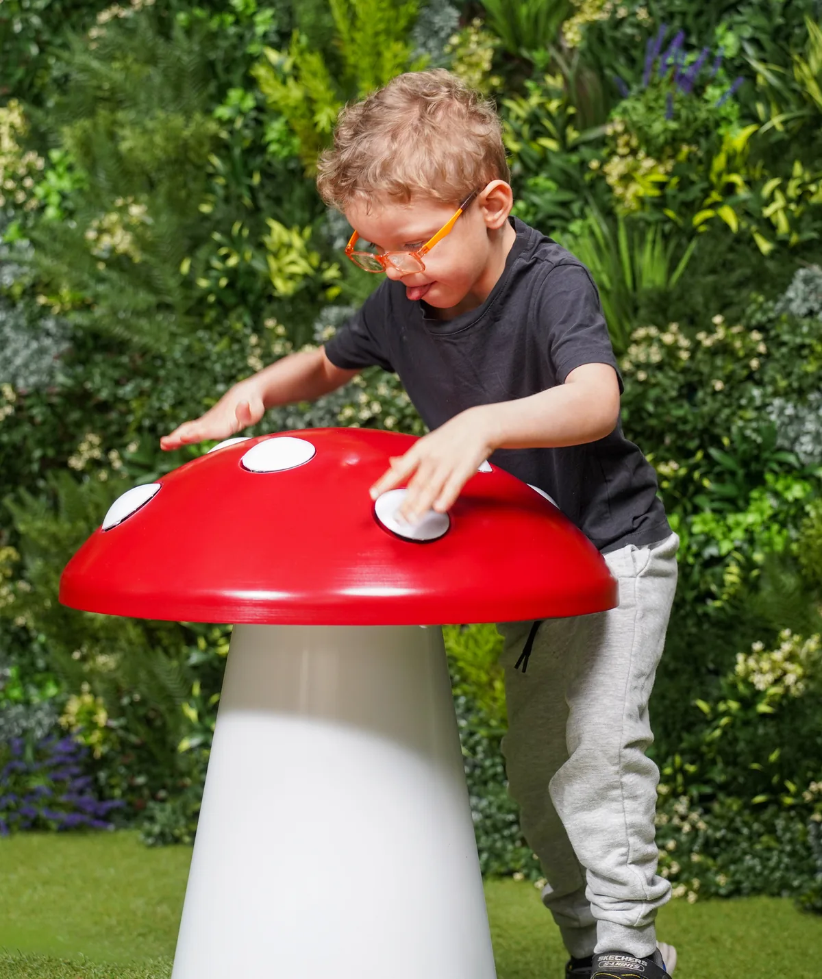 Child playing a toadstool drum